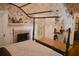 Charming bedroom featuring a canopy bed with intricate lacework and a decorative fireplace at 219 Rigby St, Reevesville, SC 29471