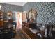 Elegant dining room showcasing antique furnishings and patterned blue wallpaper at 219 Rigby St, Reevesville, SC 29471