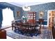 Sophisticated dining area with hardwood floors, ornate chandelier, and patterned blue wallpaper at 219 Rigby St, Reevesville, SC 29471