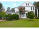Charming white house with lush landscaping and a brick pathway at 219 Rigby St, Reevesville, SC 29471