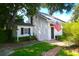 Charming cottage with white siding, flag, landscaped yard, and brick pathway at 219 Rigby St, Reevesville, SC 29471