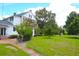 Picturesque property featuring a classic home, manicured lawn, and a brick path at 219 Rigby St, Reevesville, SC 29471