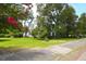 Two-story house exterior with mature landscaping and blooming trees on a sunny day at 219 Rigby St, Reevesville, SC 29471