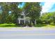 Two-story home with mature trees, a manicured lawn, and a welcoming entrance at 219 Rigby St, Reevesville, SC 29471
