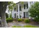 Elegant home with large columns, black shutters, and a beautifully landscaped front yard at 219 Rigby St, Reevesville, SC 29471