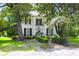 Beautiful two-story home with a brick path, mature trees, and well-maintained landscaping at 219 Rigby St, Reevesville, SC 29471