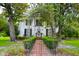 Charming two-story home featuring a beautifully landscaped yard and inviting entry archway at 219 Rigby St, Reevesville, SC 29471
