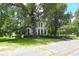 Classic two-story home framed by mature trees with lush lawn and trimmed hedges at 219 Rigby St, Reevesville, SC 29471