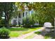 Charming home with a brick-lined drive and lush, green lawn, framed by mature trees at 219 Rigby St, Reevesville, SC 29471