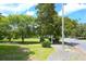 Manicured front lawn with lush trees bordering a street at 219 Rigby St, Reevesville, SC 29471