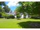 Picturesque front yard with flowering trees framing a charming white home, showcasing curb appeal at 219 Rigby St, Reevesville, SC 29471