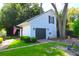 Detached garage with a black door, garden bench, and an American flag detail at 219 Rigby St, Reevesville, SC 29471