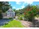 Charming greenhouse with intricate details beside vibrant flowers and a cozy bench at 219 Rigby St, Reevesville, SC 29471