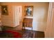 Hallway features hardwood floors, classic wainscoting, and decorative art at 219 Rigby St, Reevesville, SC 29471