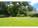 Expansive lawn with verdant trees and trimmed hedges enhance the property's curb appeal at 219 Rigby St, Reevesville, SC 29471