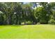 Manicured lawn featuring a decorative bench and foliage, offering a serene outdoor space at 219 Rigby St, Reevesville, SC 29471
