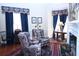 Cozy living room featuring ornate armchairs, a fireplace, and classic decor offering a comfortable and stylish space at 219 Rigby St, Reevesville, SC 29471