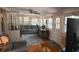 Bright sunroom with wood floors, ceiling fan, and comfortable gray sofa with plenty of natural light at 219 Rigby St, Reevesville, SC 29471