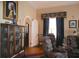 Elegant living room with a display cabinet, arched doorway, and patterned armchairs for a stylish and comfortable setting at 219 Rigby St, Reevesville, SC 29471