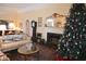 Inviting living room with a festive Christmas tree, fireplace, and comfortable seating creates a warm and welcoming atmosphere at 219 Rigby St, Reevesville, SC 29471