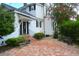 Charming patio featuring brick pavers, benches, and landscaped greenery around a classic white house at 219 Rigby St, Reevesville, SC 29471