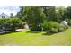 Expansive yard featuring a greenhouse, gazebo, and manicured landscaping offering an idyllic outdoor retreat at 219 Rigby St, Reevesville, SC 29471