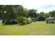 Picturesque backyard featuring a manicured lawn, gazebo, American flag, and ample space for outdoor activities at 219 Rigby St, Reevesville, SC 29471