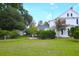 Scenic yard featuring home, mature trees and verdant lawn at 219 Rigby St, Reevesville, SC 29471