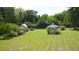 Spacious backyard with a well-kept lawn, gazebo, American flag, and garden, perfect for outdoor enjoyment and relaxation at 219 Rigby St, Reevesville, SC 29471