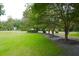 Large front yard with lush green lawn and mature trees. The street is visible in the background at 219 Rigby St, Reevesville, SC 29471