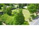 Lush, expansive property with vibrant green lawn and mature trees provides a private and serene outdoor setting at 219 Rigby St, Reevesville, SC 29471