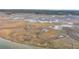 Expansive aerial view showcases meandering tidal creeks through marshland leading to the coast at 2224 Shoreline Dr, Johns Island, SC 29455