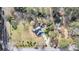 Aerial view of a landscaped property highlighting the lush green lawn, a driveway, and mature trees at 2224 Shoreline Dr, Johns Island, SC 29455