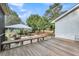 Spacious back deck featuring bench seating, stone patio area, and manicured lawn at 2224 Shoreline Dr, Johns Island, SC 29455