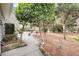 Landscaped backyard with stone path, mature trees, and decorative rock border at 2224 Shoreline Dr, Johns Island, SC 29455