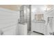 Well-lit bathroom with a glass shower, vanity, and shiplap walls at 2224 Shoreline Dr, Johns Island, SC 29455