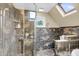 A luxurious bathroom featuring a large shower with a built-in shelf and a skylight at 2224 Shoreline Dr, Johns Island, SC 29455
