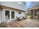 A stunning wood deck with rocking chairs, a screened-in porch and well-manicured landscaping at 2224 Shoreline Dr, Johns Island, SC 29455