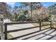 Gated driveway entrance amidst a wooded landscape, offering privacy and security at 2224 Shoreline Dr, Johns Island, SC 29455