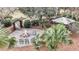 A cozy outdoor fire pit area with seating, an arbor and beautiful landscaping at 2224 Shoreline Dr, Johns Island, SC 29455