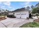 Detached two-car garage with a paved driveway and well-maintained landscaping at 2224 Shoreline Dr, Johns Island, SC 29455
