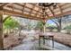 Charming backyard gazebo with table, lantern, and views of the well-manicured landscape at 2224 Shoreline Dr, Johns Island, SC 29455