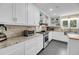 Well-lit kitchen with granite countertops, stainless steel appliances, and white cabinets at 2224 Shoreline Dr, Johns Island, SC 29455