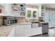 Modern kitchen features a stainless steel sink, granite countertops, and white cabinetry at 2224 Shoreline Dr, Johns Island, SC 29455
