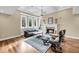 Bright living room features a fireplace, large windows, hardwood floors, and ample seating at 2224 Shoreline Dr, Johns Island, SC 29455