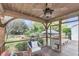 Inviting screened porch with wood ceiling, ceiling fan, and seating area with backyard views at 2224 Shoreline Dr, Johns Island, SC 29455