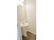 Half bathroom featuring a pedestal sink, round mirror, and stylish flooring at 232 Buchanan Cir, Goose Creek, SC 29445