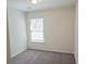 Bright bedroom with neutral carpet, white walls, and a window with blinds at 232 Buchanan Cir, Goose Creek, SC 29445