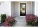 Inviting front entrance featuring a black door with glass, blooming shrubs, and a tidy walkway at 232 Buchanan Cir, Goose Creek, SC 29445
