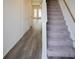 Bright hallway showcasing hardwood floors, a staircase with carpet, and white trim at 232 Buchanan Cir, Goose Creek, SC 29445